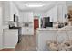 Well-lit kitchen with granite countertops, stainless steel appliances, white cabinetry, and hardwood floors at 49 Inverness Ct, Hiram, GA 30141