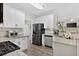 Modern kitchen featuring white cabinets, stainless steel appliances, and granite countertops at 49 Inverness Ct, Hiram, GA 30141