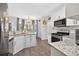 Bright kitchen with white cabinets, granite countertops, and stainless steel appliances at 49 Inverness Ct, Hiram, GA 30141