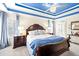 Main bedroom features a bed with a wood headboard, side tables, and a view of the entry at 49 Inverness Ct, Hiram, GA 30141