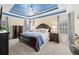 Elegant primary bedroom featuring a tray ceiling, carpet, a ceiling fan, tv and stylish furnishings at 49 Inverness Ct, Hiram, GA 30141