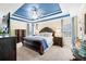 Spacious main bedroom boasts a tray ceiling, ceiling fan, and ample natural light at 49 Inverness Ct, Hiram, GA 30141