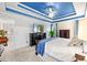 Main bedroom with blue ceiling feature, TV, dresser, and doorway view at 49 Inverness Ct, Hiram, GA 30141
