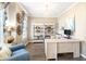Bright and airy home office featuring a modern desk, stylish shelving, and a cozy seating area at 49 Inverness Ct, Hiram, GA 30141