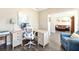 Comfortable home office space with a large desk, ergonomic chair, and ample natural light at 49 Inverness Ct, Hiram, GA 30141