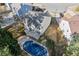 Aerial view of the home's backyard, showcasing a partially covered pool and well-maintained lawn at 6005 Pattingham Dr, Roswell, GA 30075