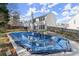 Backyard view of a two-story home with a covered in-ground swimming pool at 6005 Pattingham Dr, Roswell, GA 30075