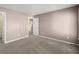 Spacious bedroom with neutral carpet, paint, and a view to the hallway at 6005 Pattingham Dr, Roswell, GA 30075