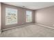 Bedroom featuring two large windows and neutral carpet at 6005 Pattingham Dr, Roswell, GA 30075