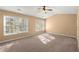 Bright bedroom with neutral carpet and plenty of natural light from three windows at 6005 Pattingham Dr, Roswell, GA 30075