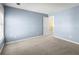 Neutral bedroom with carpet, light-blue walls, and doorway view at 6005 Pattingham Dr, Roswell, GA 30075