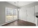 Inviting dining area with a chandelier and large window, filling the space with natural light at 6005 Pattingham Dr, Roswell, GA 30075