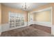 Inviting dining room featuring large windows for natural light and carpeted floors at 6005 Pattingham Dr, Roswell, GA 30075