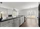 Modern kitchen featuring granite countertops and a view to the living area at 6005 Pattingham Dr, Roswell, GA 30075