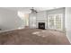 Bright living room with a fireplace, ceiling fan, and an abundance of natural light at 6005 Pattingham Dr, Roswell, GA 30075