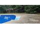 In-ground swimming pool featuring built-in steps and a surrounding concrete patio at 6005 Pattingham Dr, Roswell, GA 30075