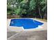 Backyard pool with ladder and stairs, surrounded by a concrete patio at 6005 Pattingham Dr, Roswell, GA 30075