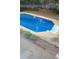 Backyard pool with a ladder and steps, surrounded by concrete and landscaping at 6005 Pattingham Dr, Roswell, GA 30075