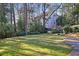 Expansive backyard featuring a well-maintained lawn, mature trees, and ample space for outdoor activities at 1258 Merry Ne Ln, Atlanta, GA 30329