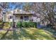Backyard view, featuring a patio, lawn, and access to a detached carport with ample shade at 1258 Merry Ne Ln, Atlanta, GA 30329