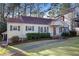 Quaint home with a bright exterior, red front door, gray shutters, and a neatly maintained lawn at 1258 Merry Ne Ln, Atlanta, GA 30329
