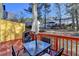 Enjoy outdoor dining on this back deck featuring a table, chairs, a grill, and a yellow storage shed at 4008 Bayside Cir, Atlanta, GA 30340