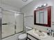 Bright bathroom features a shower with glass doors, a framed mirror, and modern fixtures at 4008 Bayside Cir, Atlanta, GA 30340