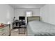 Cozy bedroom features a neutral color scheme, a convenient desk area, and a window providing natural light at 4008 Bayside Cir, Atlanta, GA 30340