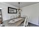Traditional dining room with wood table, chandelier, mirror, and seating for four at 4008 Bayside Cir, Atlanta, GA 30340