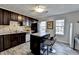 Spacious kitchen with dark wood cabinetry, stainless steel appliances, and a breakfast bar at 4008 Bayside Cir, Atlanta, GA 30340