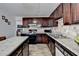 Spacious kitchen with dark wood cabinetry, stainless steel appliances, and a breakfast bar at 4008 Bayside Cir, Atlanta, GA 30340