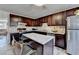 Spacious kitchen with dark wood cabinetry, stainless steel appliances, and a breakfast bar at 4008 Bayside Cir, Atlanta, GA 30340