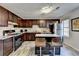 Spacious kitchen with dark wood cabinetry, stainless steel appliances, and a breakfast bar at 4008 Bayside Cir, Atlanta, GA 30340