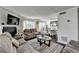 Cozy living room with fireplace, large windows, and modern decor that flows into the dining area at 4008 Bayside Cir, Atlanta, GA 30340