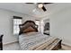 Comfortable main bedroom featuring a decorative bed frame, ceiling fan, and natural light at 4008 Bayside Cir, Atlanta, GA 30340