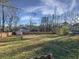 Large backyard featuring a wooden fence, mature trees, and a storage shed at 43 Landmark Sw Ln, Marietta, GA 30060