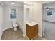 Well-lit bathroom with tiled floors, a bathtub, and a wooden vanity at 43 Landmark Sw Ln, Marietta, GA 30060