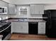 Charming kitchen featuring modern appliances, gray cabinetry, and stone countertops at 43 Landmark Sw Ln, Marietta, GA 30060