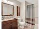 Well-lit bathroom featuring modern vanity and shower with stylish curtain at 1006 Walnut Dr, Lawrenceville, GA 30044