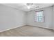 Bedroom featuring carpeted floor, ceiling fan, and a bright window at 1006 Walnut Dr, Lawrenceville, GA 30044