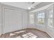 Sun-filled bedroom featuring natural light from a bay window and a spacious closet at 1006 Walnut Dr, Lawrenceville, GA 30044