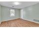 Bedroom with sleek hardwood flooring and natural light from a large window at 1006 Walnut Dr, Lawrenceville, GA 30044