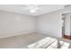 A carpeted bedroom with neutral-colored walls and a sunbeam at 1006 Walnut Dr, Lawrenceville, GA 30044