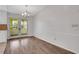 Light dining room with wood floors and French doors, offering a tranquil space at 1006 Walnut Dr, Lawrenceville, GA 30044