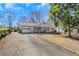 Inviting single-story home with a covered front porch, attached garage, and well-maintained lawn, exuding curb appeal at 1006 Walnut Dr, Lawrenceville, GA 30044