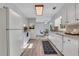 Well-lit kitchen with white cabinets and appliances, and a view into the dining area at 1006 Walnut Dr, Lawrenceville, GA 30044