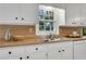 Bright kitchen sink area with white cabinets and butcher block countertops at 1006 Walnut Dr, Lawrenceville, GA 30044