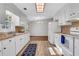 White kitchen offers a functional layout and a seamless transition to the dining area at 1006 Walnut Dr, Lawrenceville, GA 30044