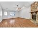 Cozy living room featuring a stone fireplace, hardwood floors, and natural light, creating a warm and inviting ambiance at 1006 Walnut Dr, Lawrenceville, GA 30044