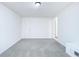 Bedroom featuring painted brick wall and light gray carpet at 1877 Glenmar Dr, Decatur, GA 30032